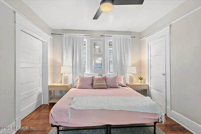 a bedroom with a bed and wooden floor