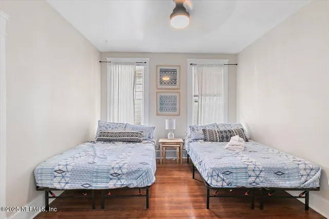 a view of a room with furniture and wooden floor