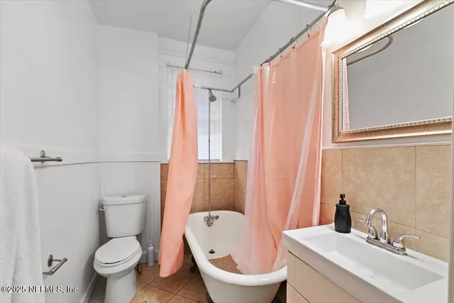 a white toilet sitting next to a bathroom sink