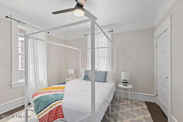 a bedroom with a bed and a window