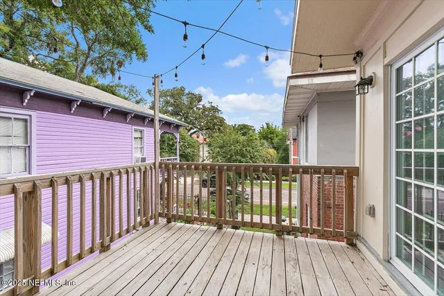 a view of a balcony with wooden floor