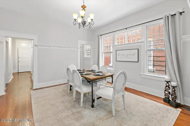 a view of a dining room with furniture and chandelier