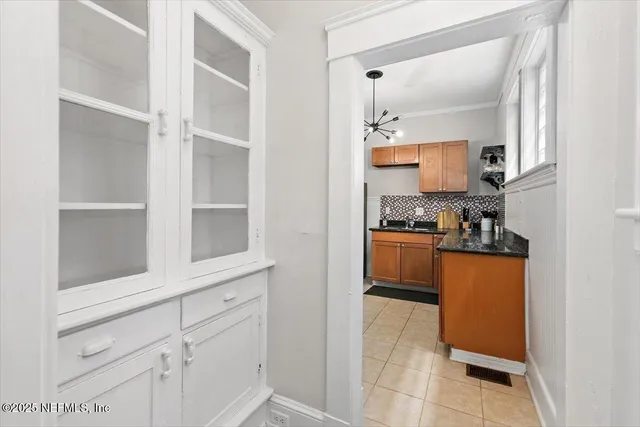 a kitchen with white cabinets and a stove