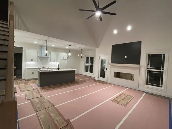 a large white kitchen with a stove top oven a sink and dishwasher