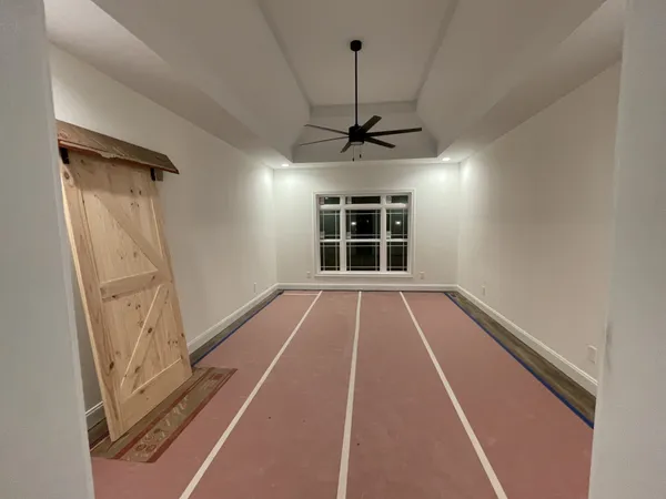 an empty room with a empty space and a ceiling fan