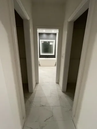 an empty room with a empty space and windows