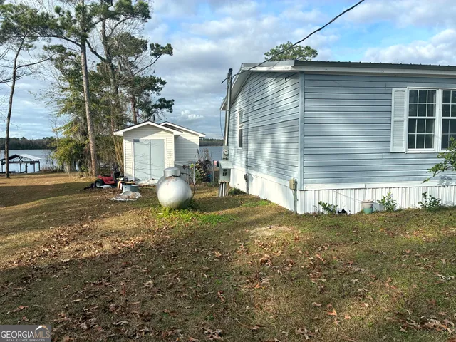 a backyard of a house with table and chairs