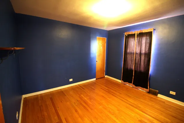 a bed room with a bed and a night stand