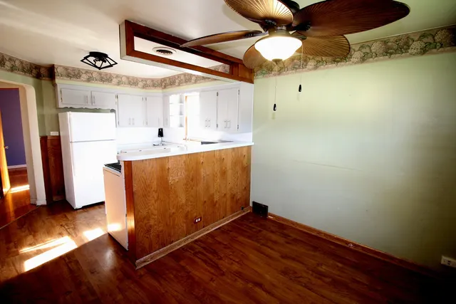 a view of a kitchen with wooden floor