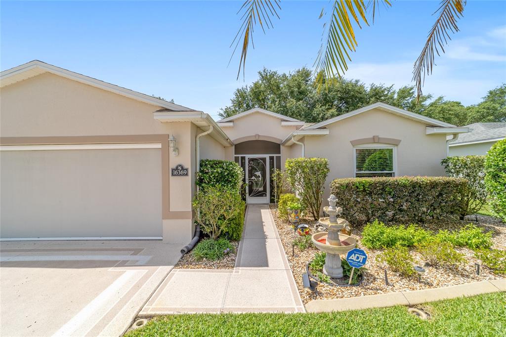 16369 Southwest 14th Avenue Road Ocala, FL 34473 - Photo 5 of 49 a front view of a house with garden