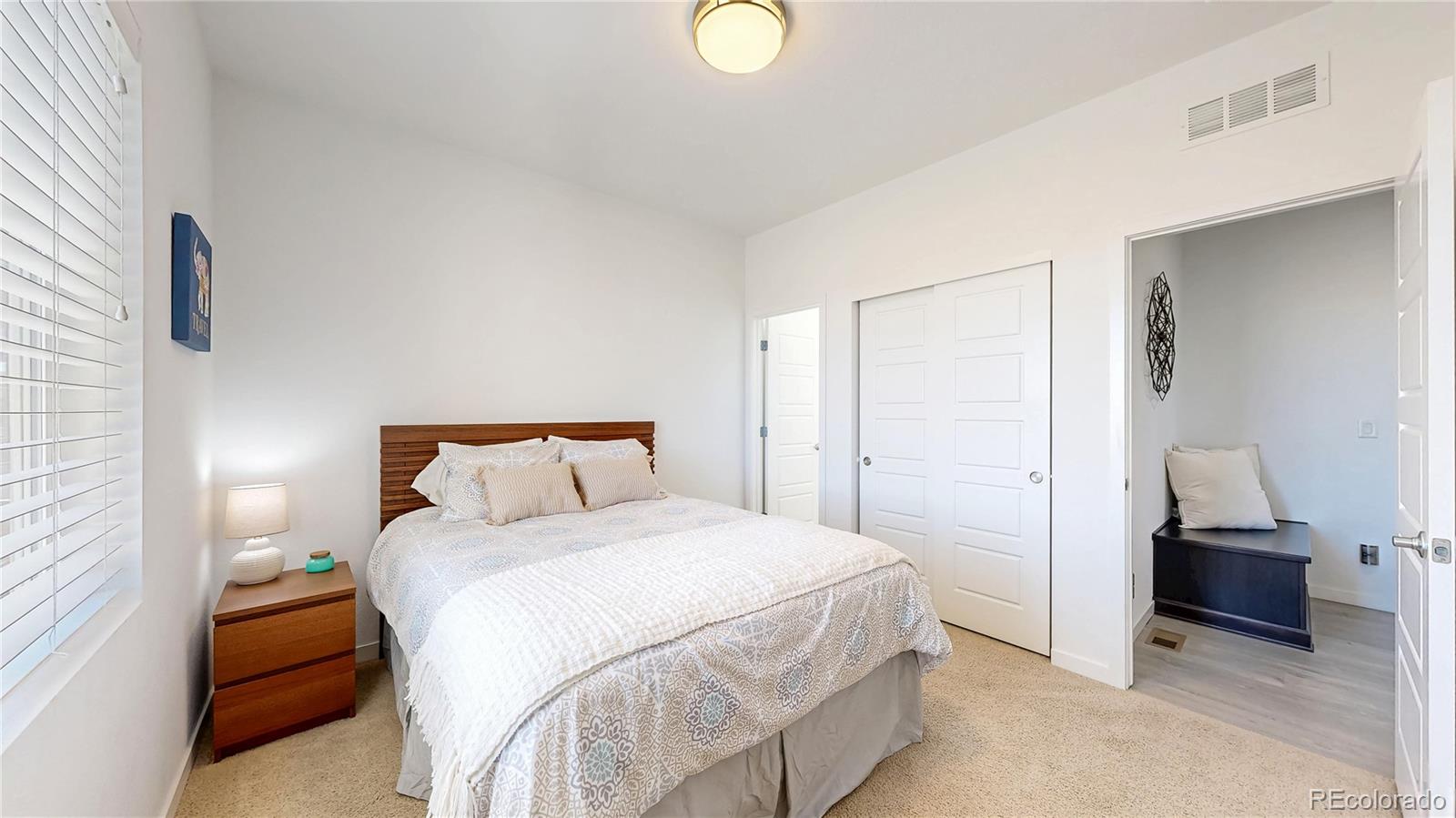 13950 Box Turtle Loop Parker, CO 80134 - Photo 13 of 48 a bedroom with a bed and a lamp