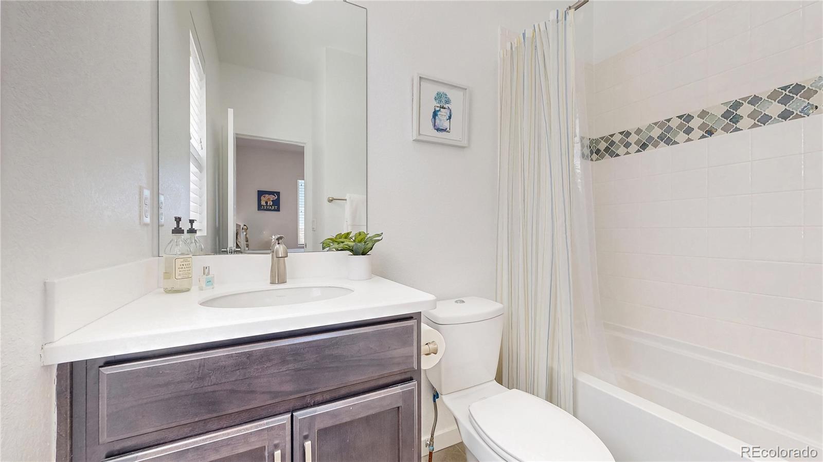 13950 Box Turtle Loop Parker, CO 80134 - Photo 14 of 48 a bathroom with a sink toilet and shower