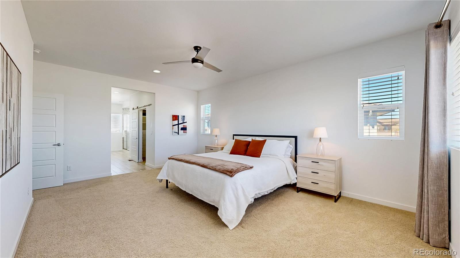 13950 Box Turtle Loop Parker, CO 80134 - Photo 16 of 48 a spacious bedroom with a bed and a window
