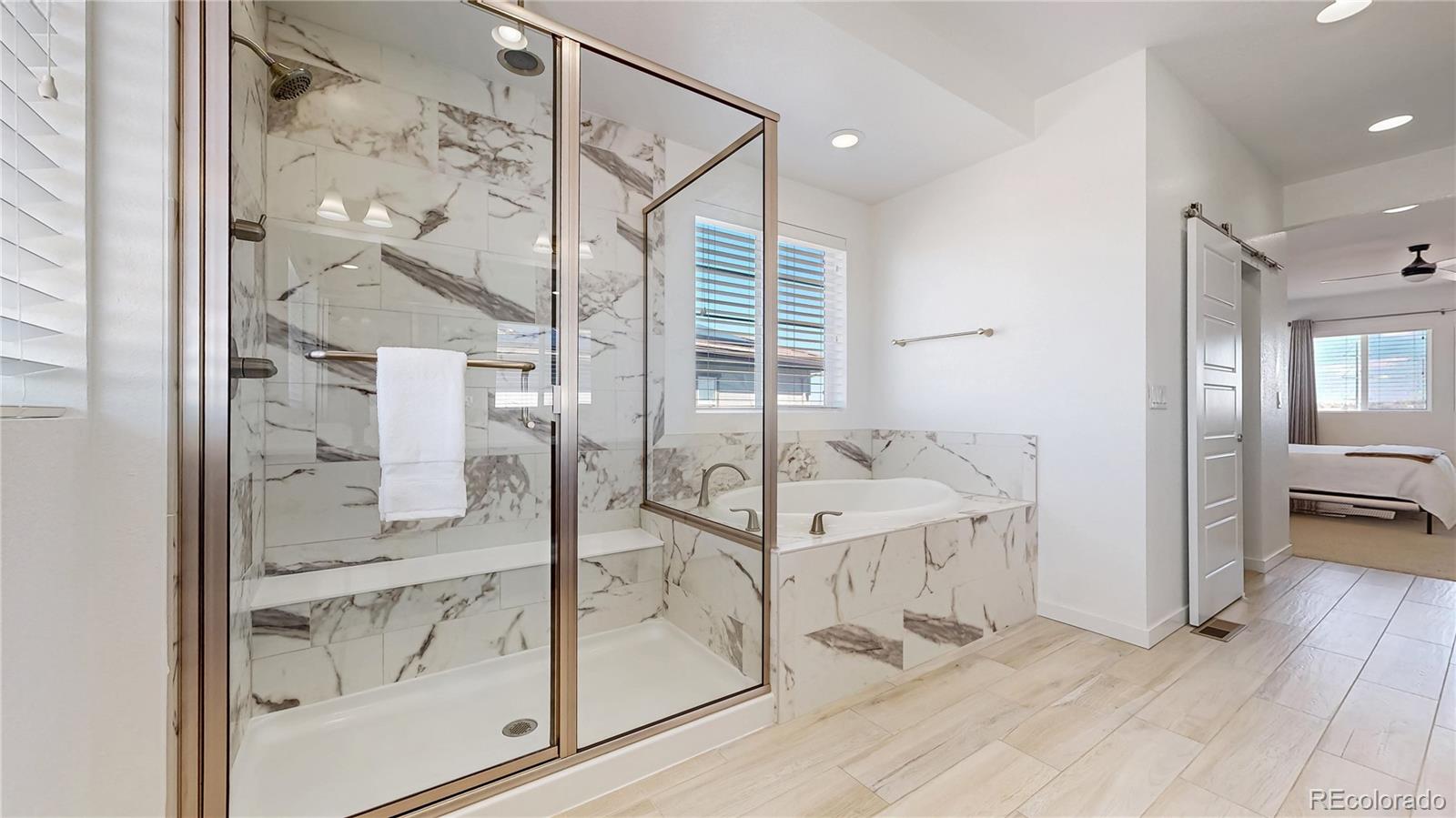 13950 Box Turtle Loop Parker, CO 80134 - Photo 17 of 48 a bathroom with a glass shower door and a sink