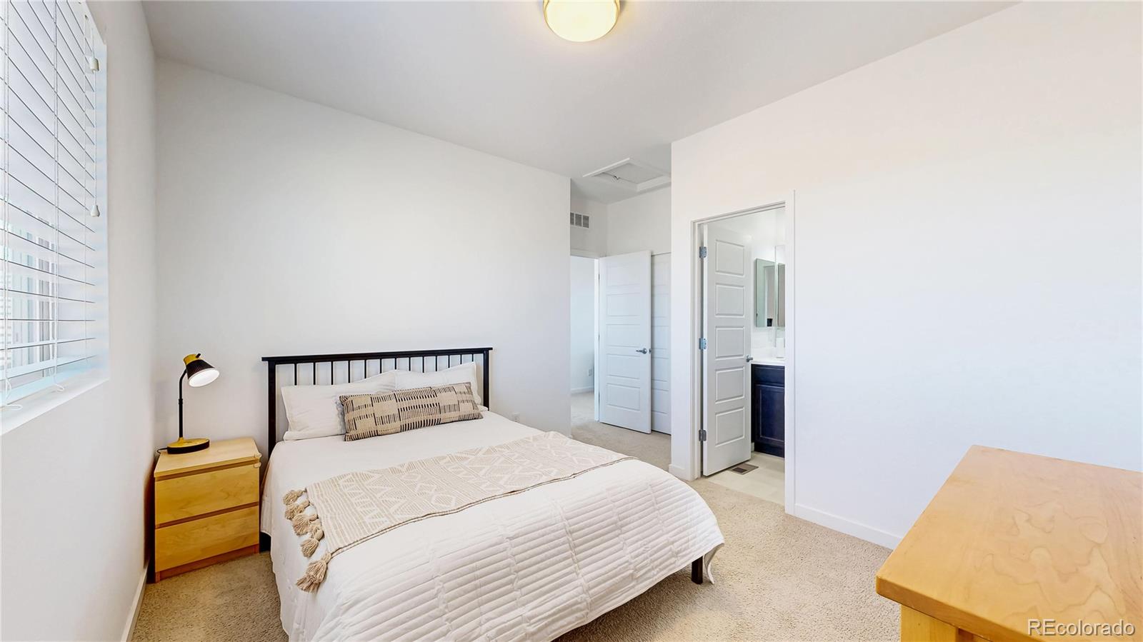 13950 Box Turtle Loop Parker, CO 80134 - Photo 19 of 48 a bedroom with a bed and a lamp