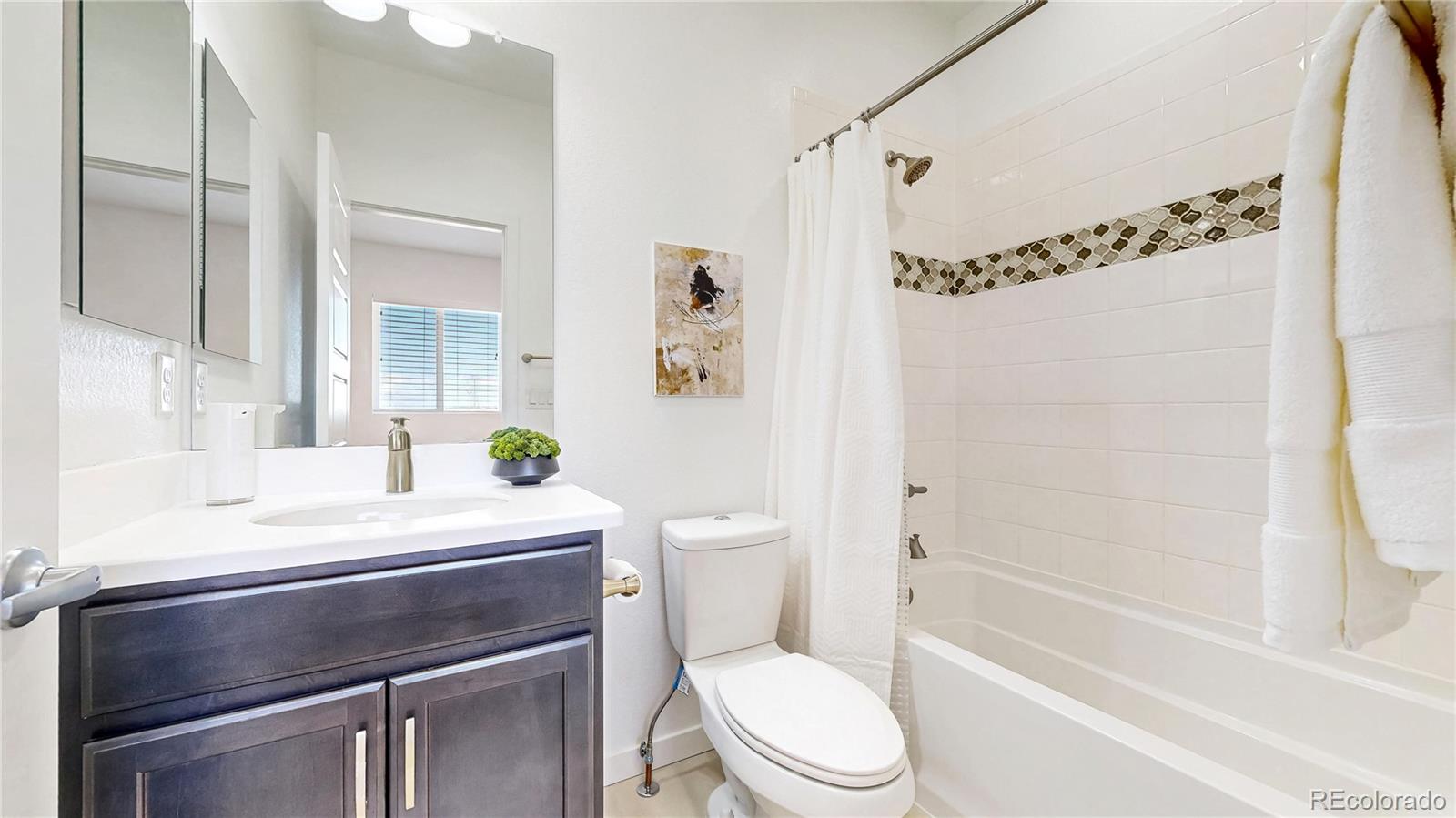 13950 Box Turtle Loop Parker, CO 80134 - Photo 20 of 48 a bathroom with a sink a toilet and a mirror