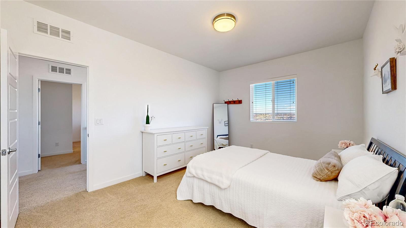13950 Box Turtle Loop Parker, CO 80134 - Photo 21 of 48 a bedroom with a bed and a dresser