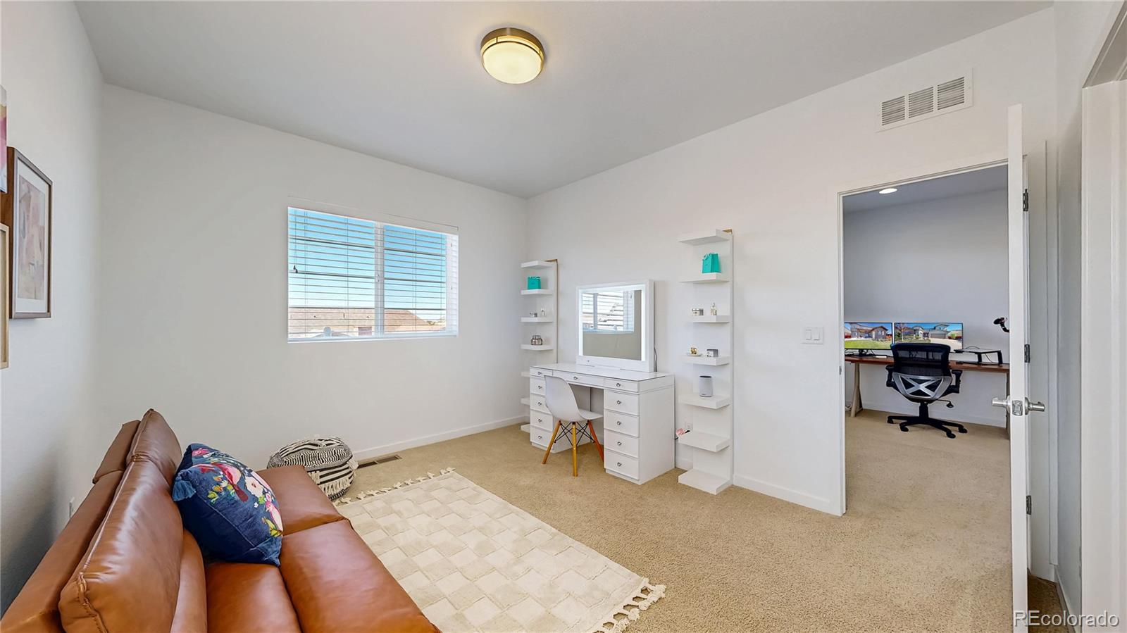 13950 Box Turtle Loop Parker, CO 80134 - Photo 23 of 48 a bed room with furniture and a book shelf