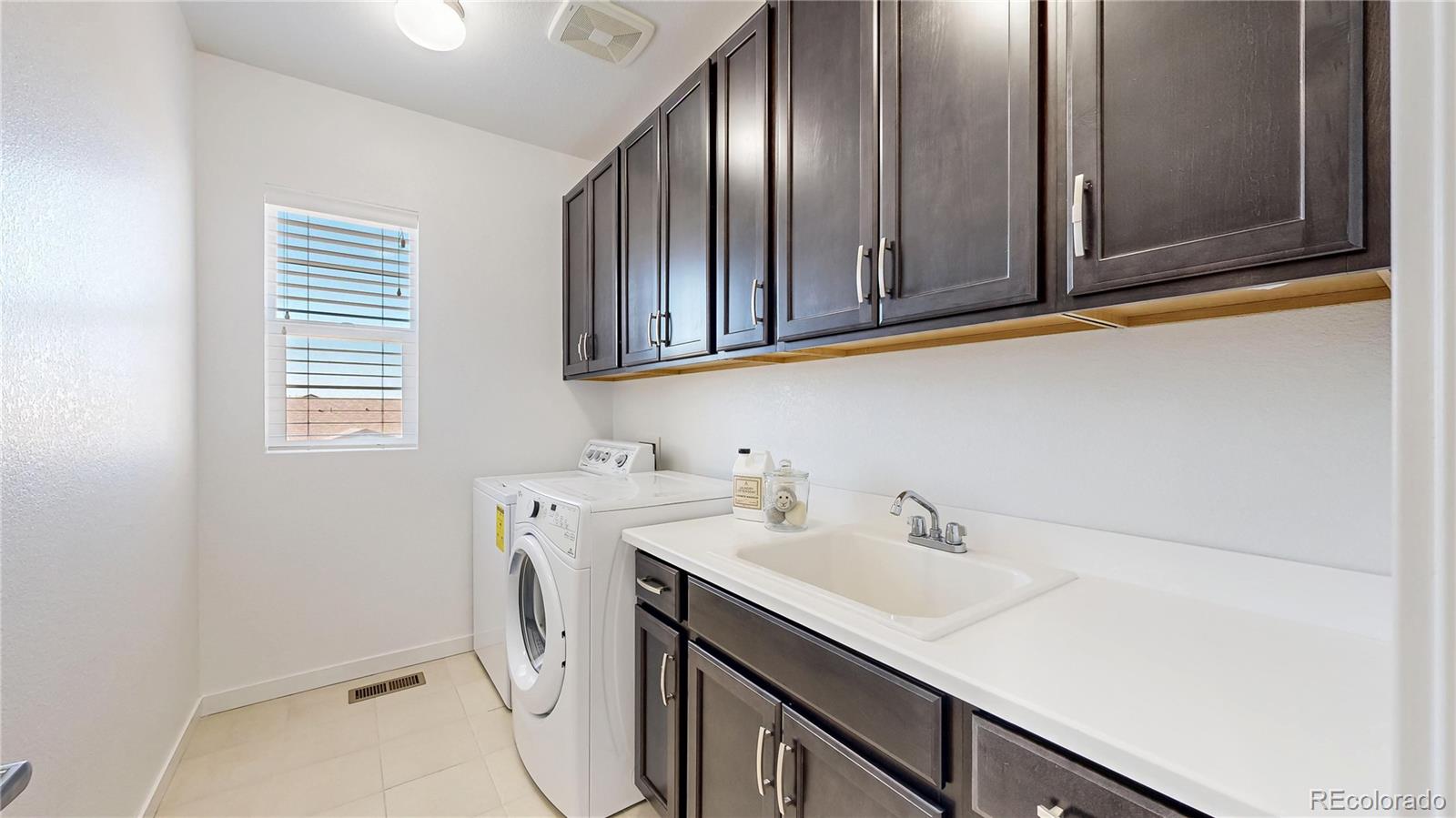 13950 Box Turtle Loop Parker, CO 80134 - Photo 25 of 48 a utility room with a sink washer and dryer