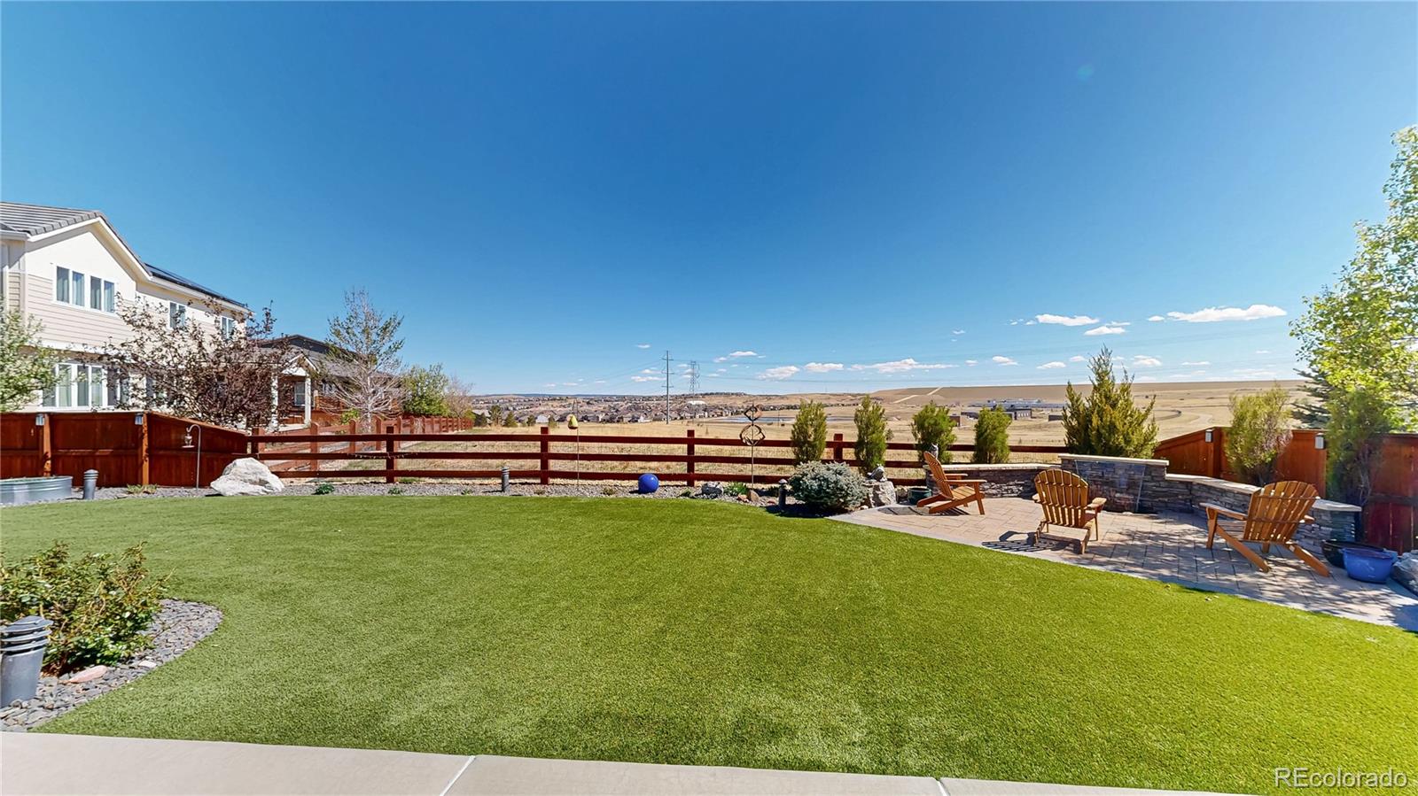 13950 Box Turtle Loop Parker, CO 80134 - Photo 31 of 48 a view of a patio with table and chairs a barbeque