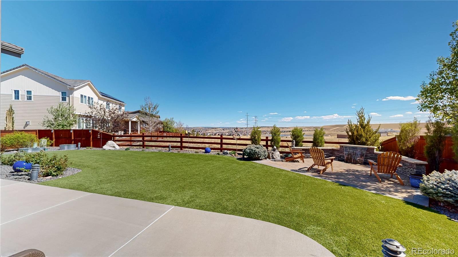 13950 Box Turtle Loop Parker, CO 80134 - Photo 32 of 48 a view of a house with backyard sitting area and garden