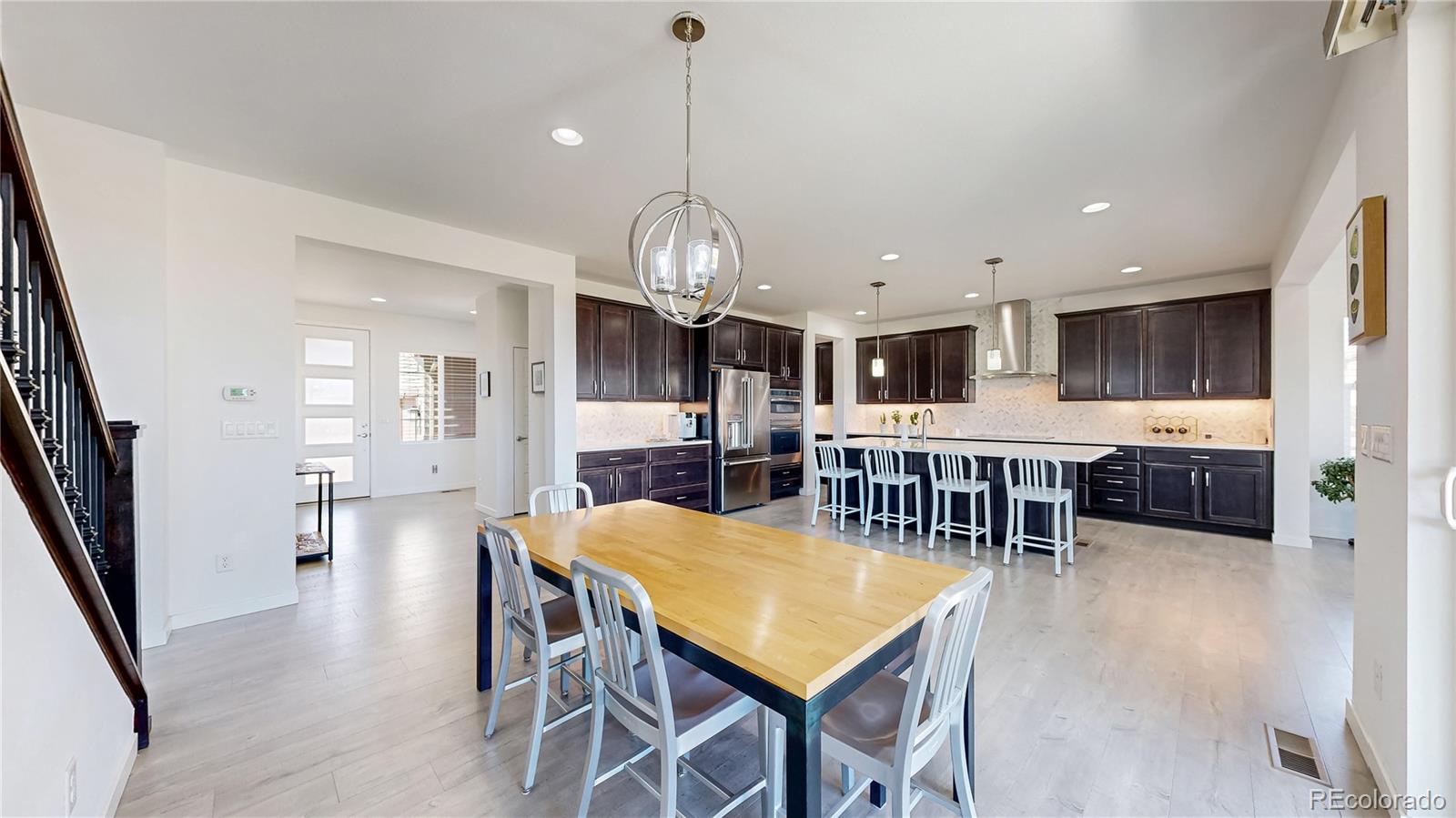 13950 Box Turtle Loop Parker, CO 80134 - Photo 9 of 48 a large kitchen with a table and chairs