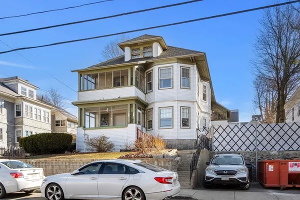 a front view of a house with parking space