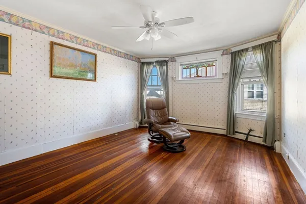 a room with wooden floor and windows