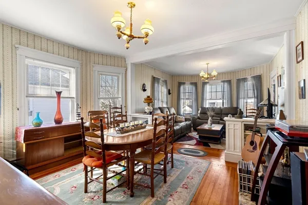 a view of a dining room with furniture window and wooden floor