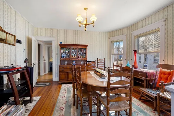 a view of a livingroom with furniture window and wooden floor