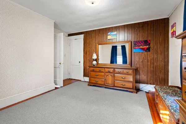an empty room with windows and cabinet