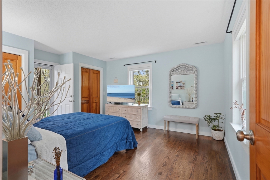 55 Ridgeview Drive Falmouth, MA 02540 - Photo 27 of 32 a bedroom with a bed and a wooden floor