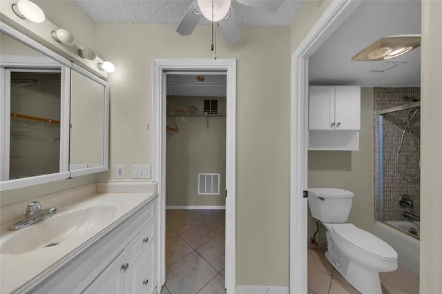 a bathroom with a toilet a sink and glass door