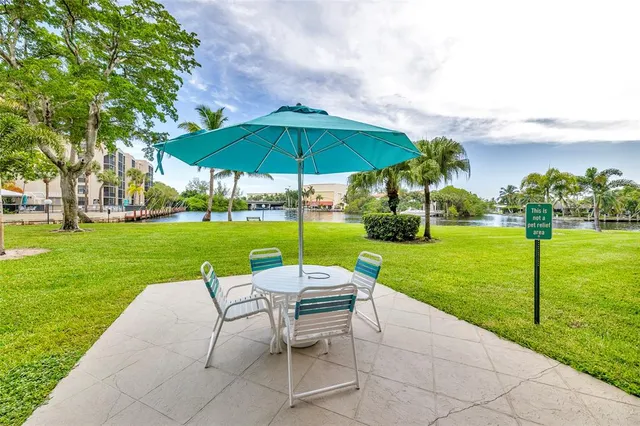 a view of a yard with furniture and garden