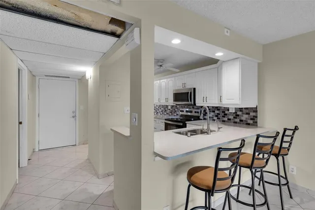 a kitchen with a table and chairs in it