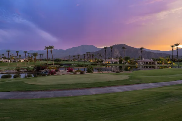 a backyard of a house with barbeque oven table and chairs