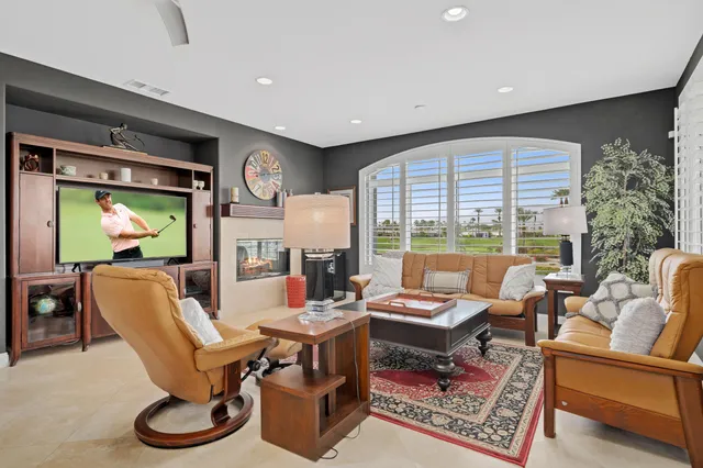a kitchen with kitchen island granite countertop wooden cabinets and a refrigerator