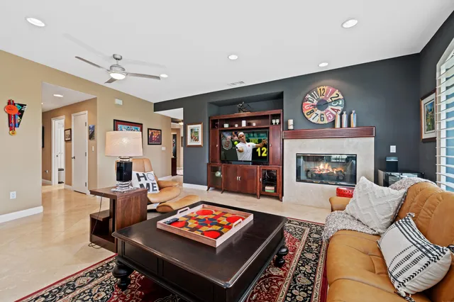 a kitchen with stainless steel appliances granite countertop a sink a counter space and living room view