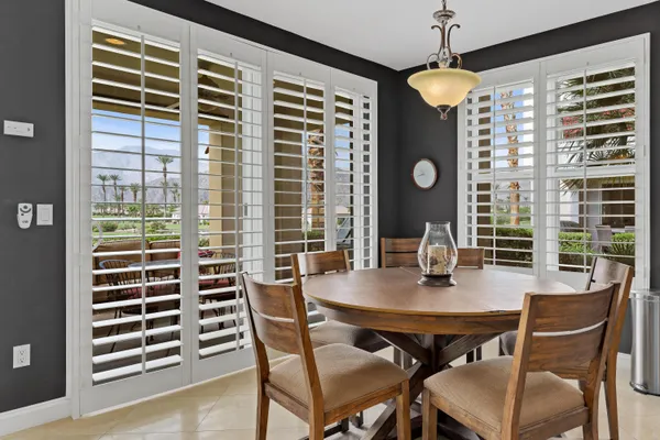 a spacious bathroom with a tub sink and mirror