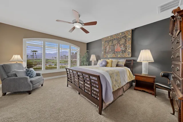 a spacious bathroom with a granite countertop sink a mirror and a shower