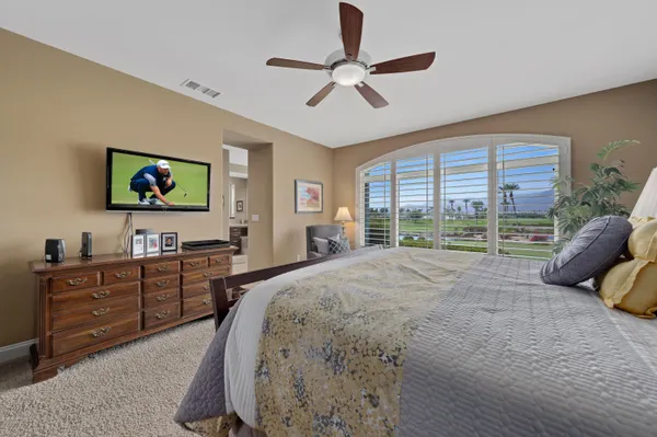 a bedroom with a bed and a lamp