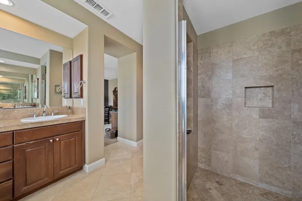 a bathroom with a double vanity sink toilet and mirror