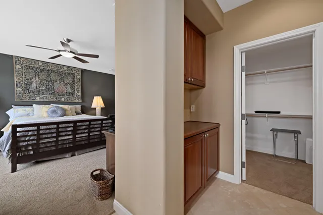 a bedroom with a bed and cabinets