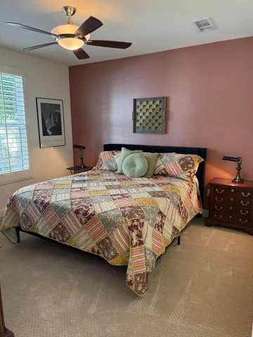 a bedroom with a bed and a couch