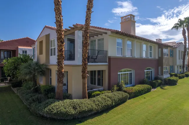 a balcony with furniture and a floor to ceiling window