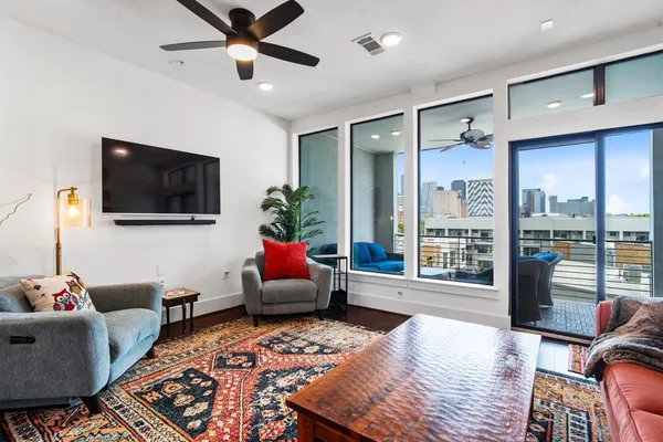 a kitchen with stainless steel appliances granite countertop a refrigerator oven a sink dishwasher and a stove with wooden floor