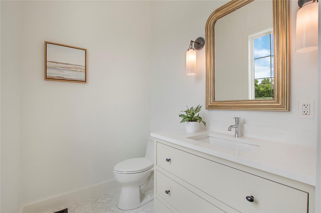 1031 Mobile Street Dallas, TX 75208 - Photo 12 of 28 a bathroom with a toilet sink and mirror