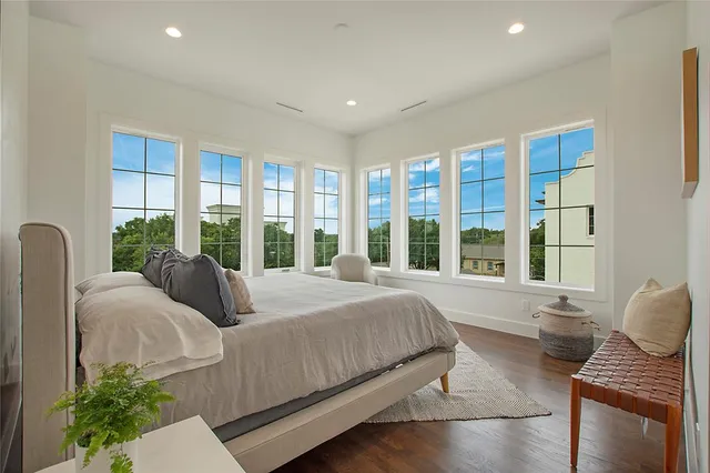 a bedroom with bed and wooden floor
