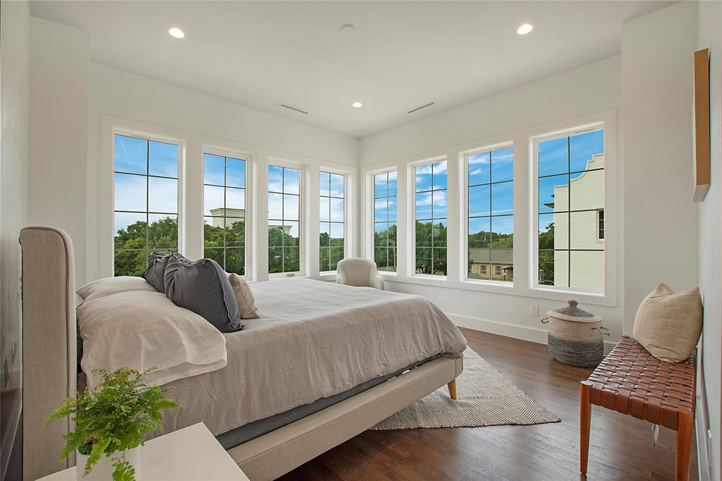 1031 Mobile Street Dallas, TX 75208 - Photo 14 of 28 a bedroom with bed and wooden floor