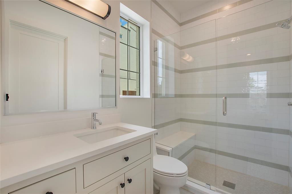 1031 Mobile Street Dallas, TX 75208 - Photo 21 of 28 a bathroom with a sink a toilet and shower